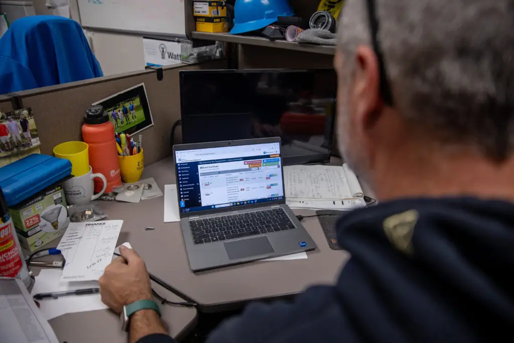 image of a man looking at espace's work order and asset management on a desktop computer